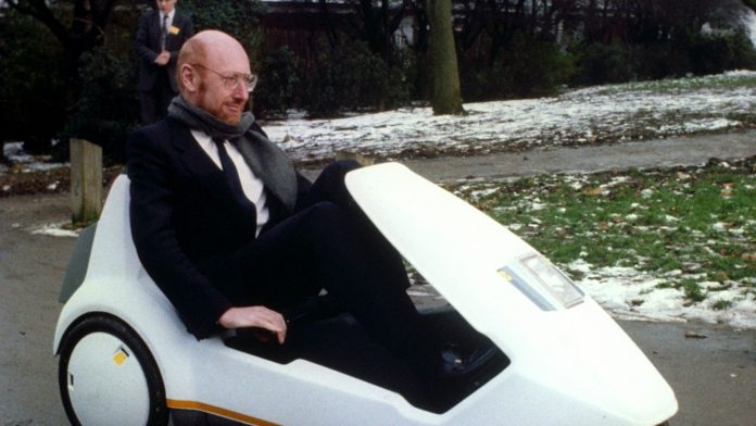 Sir Clive Sinclair demonstrates his battery-assisted pedal powered tricycle at Alexandra Palace, London, in 1985