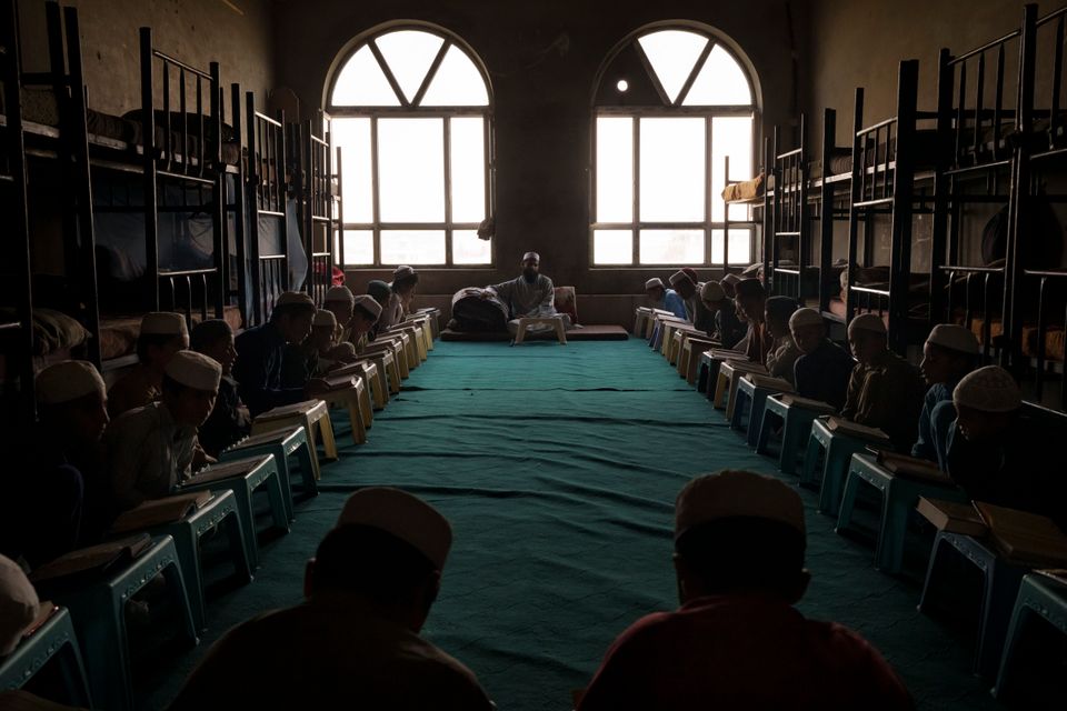 Afghan boys read the Qur'an, the holy book of Islam, during class at the Khatam al-Anbiya School in Kabul,...