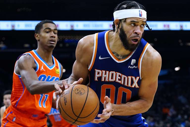 Phoenix Suns center, JaVale McGee scores a rebound off Theo Maledon of the Oklahoma City Thunder on Wednesday, December 29, 2021 (AP Photo/Ross D. Franklin)
