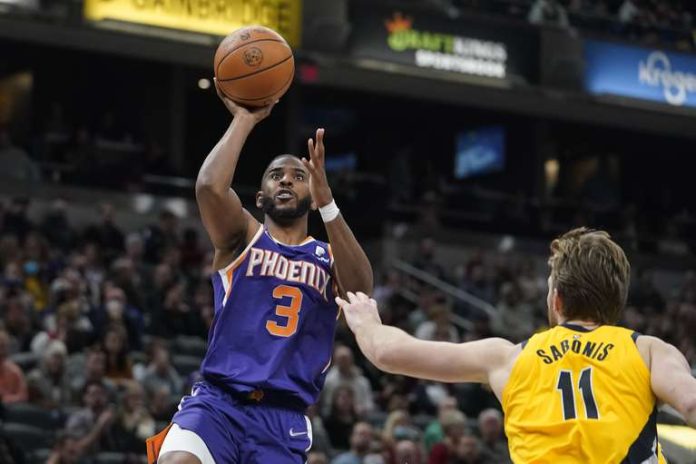 Phoenix Suns' Chris Paul (3) shoots a hit against the Indiana Pacers' Domantas Sabonis (11) during the second half of an NBA game Friday, Jan. 14, 2022, in Indianapolis.  (AP Photo/Darron Cummings)