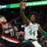 Yusuf Nurkic (27) of the Portland Trail Blazers and Robert Williams III (44) of the Boston Celtics for a rebound during the first half of an NBA game, Friday, Jan. 21, 2022, in Boston.  (Photo by Associated Press/Michael Dwyer)