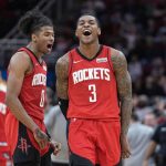 Kevin Porter Jr. (3) of the Houston Rockets celebrates with Jalen Green (0) after making a basket against the Memphis Grizzlies during the second half of an NBA basketball game on Sunday, March 6, 2022, in Houston.  The Rockets won 123-112.  (AP Photo/David J. Phillip)