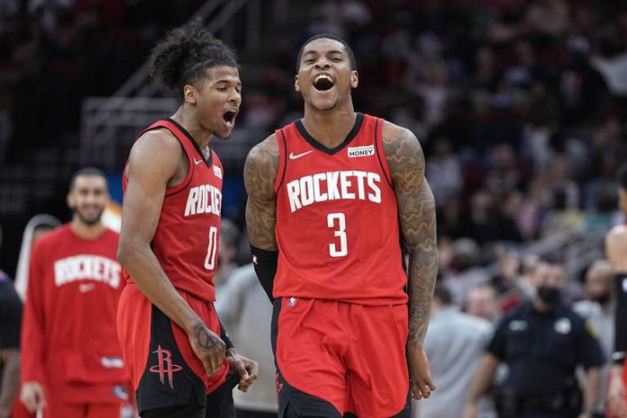 Kevin Porter Jr. (3) of the Houston Rockets celebrates with Jalen Green (0) after making a basket against the Memphis Grizzlies during the second half of an NBA basketball game on Sunday, March 6, 2022, in Houston.  The Rockets won 123-112.  (AP Photo/David J. Phillip)