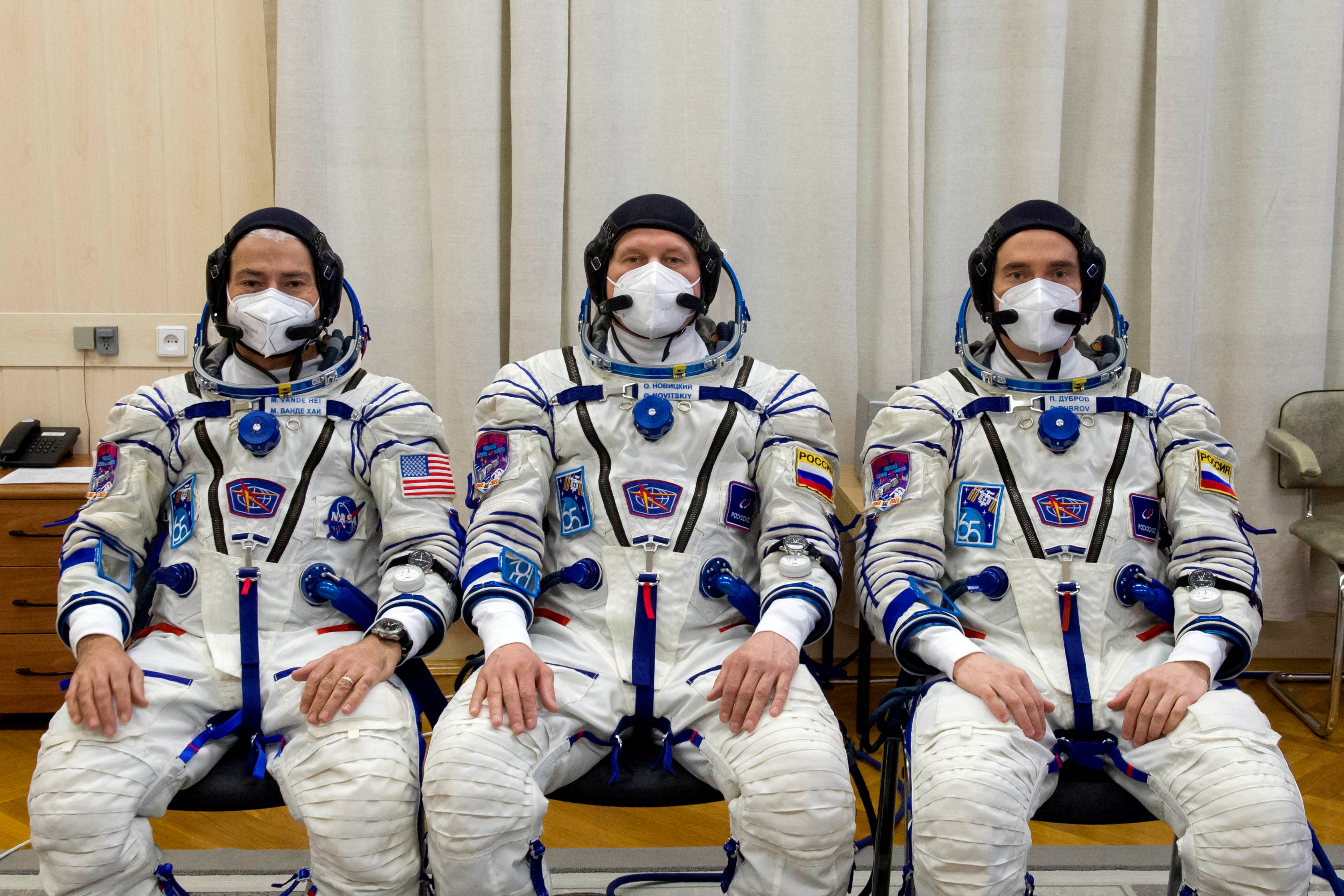 FILE PHOTO: International Space Station (ISS) crew members Mark Vandy of NASA, and astronauts Oleg Novitsky and Pyotr Dobrov of Roscosmos while out in spacesuit at the Baikonur Cosmodrome.  Irina Spector / GCTC / Roscosmos / Handout via Reuters