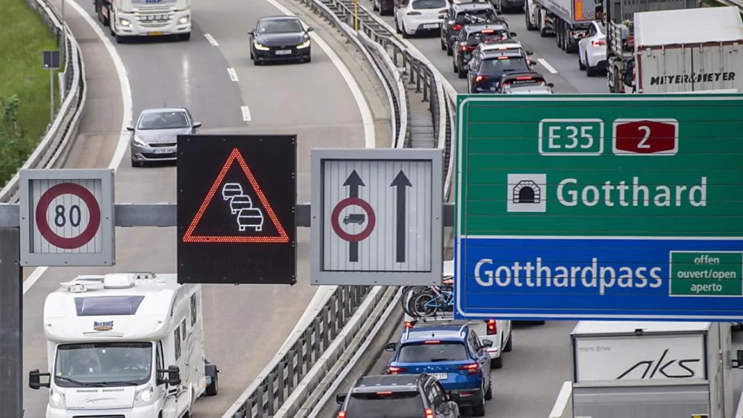 Vacationers stop in front of the Gotthard Tunnel

