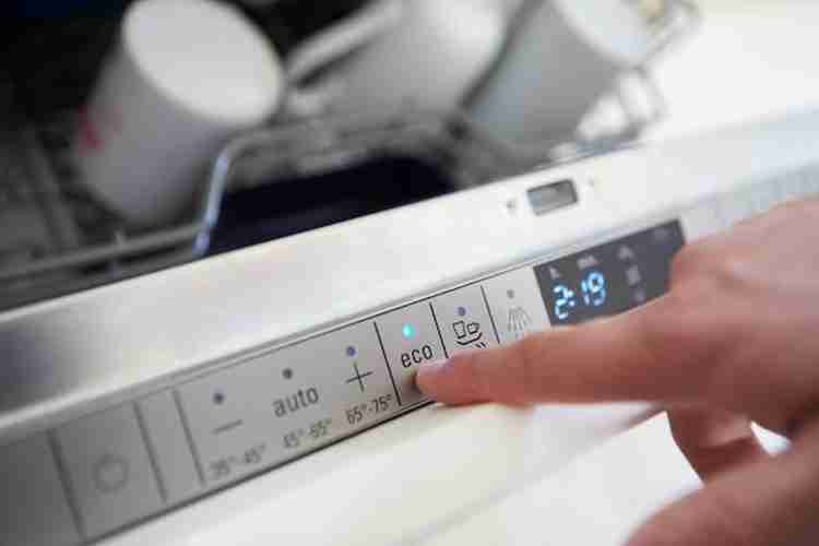 One presses the dishwasher's eco mode button